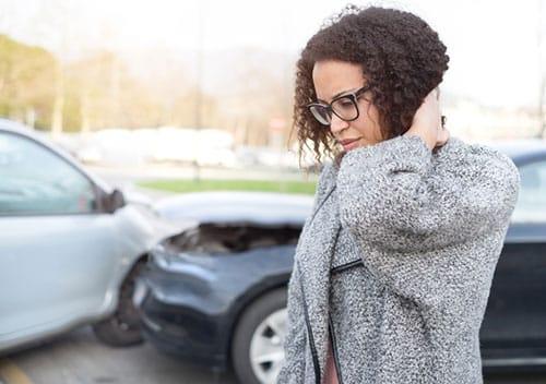 Woman holding neck after car accident