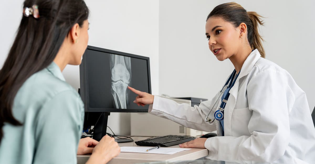 chiropractor reviewing patient x-ray