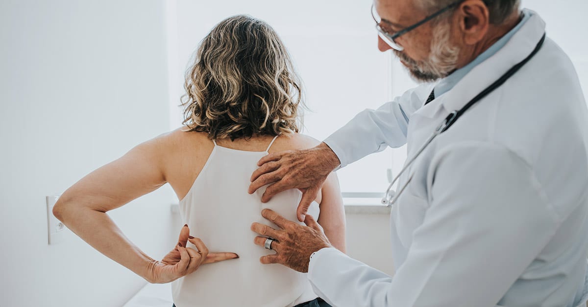 chiropractor examining patient back pain