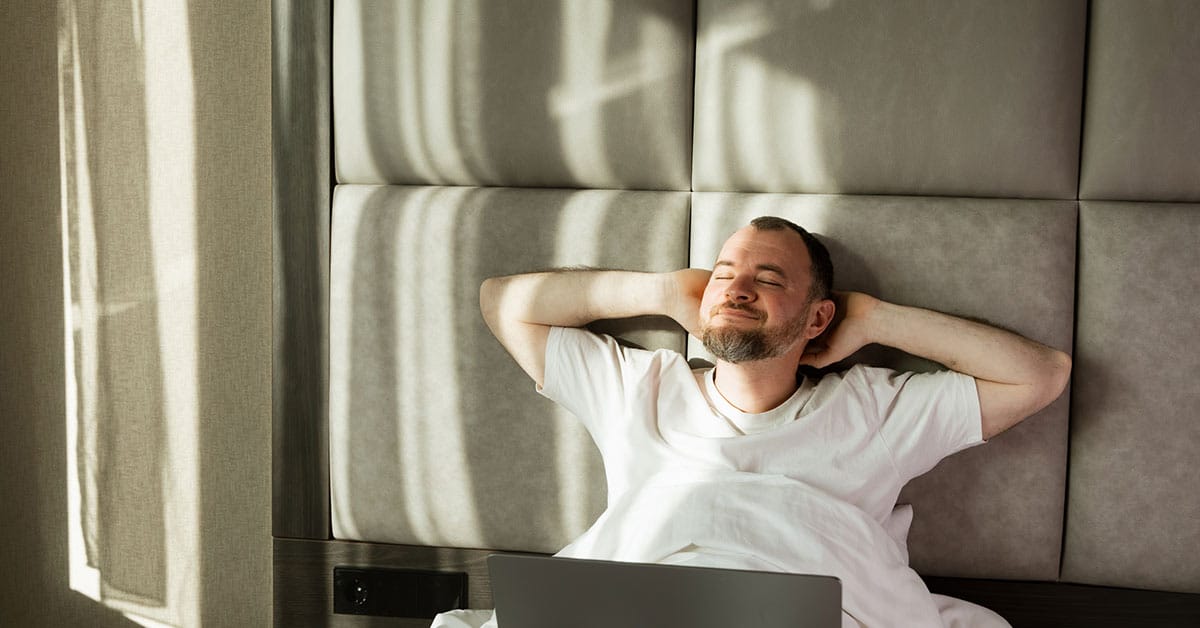 man gently stretching at home in natural light after chiropractic care