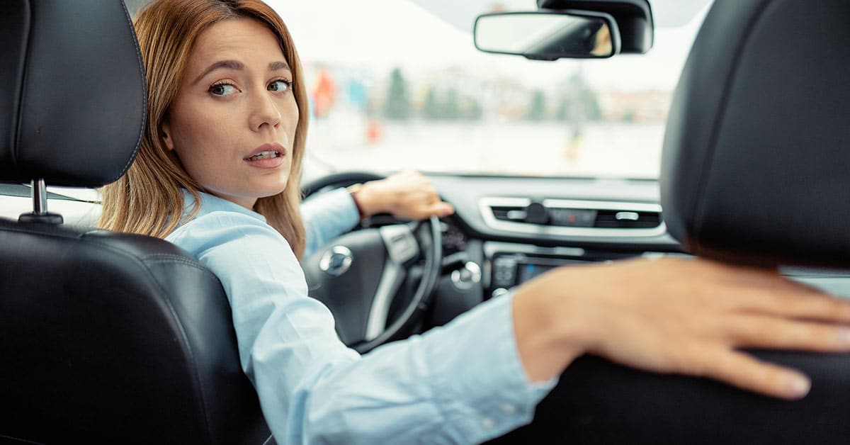 woman comfortably bending neck to check blind spot after chiropractic care